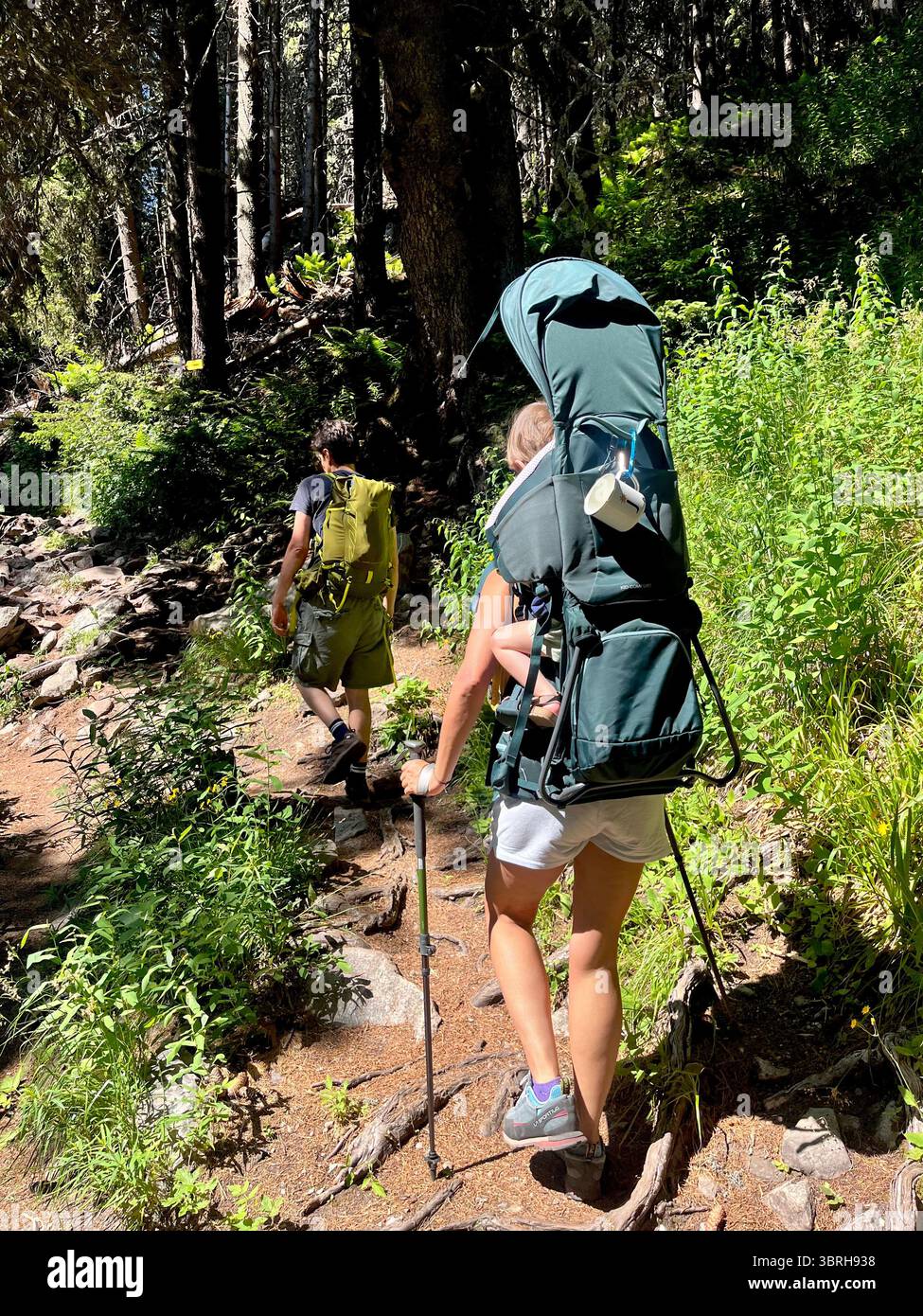 Hikers family using hiking carrier for their child in the Rila Nature Reserve and National Park, Rila Mountain, Bulgaria, Balkans, Southeastern Europe - Smartphone Captured Stock Image