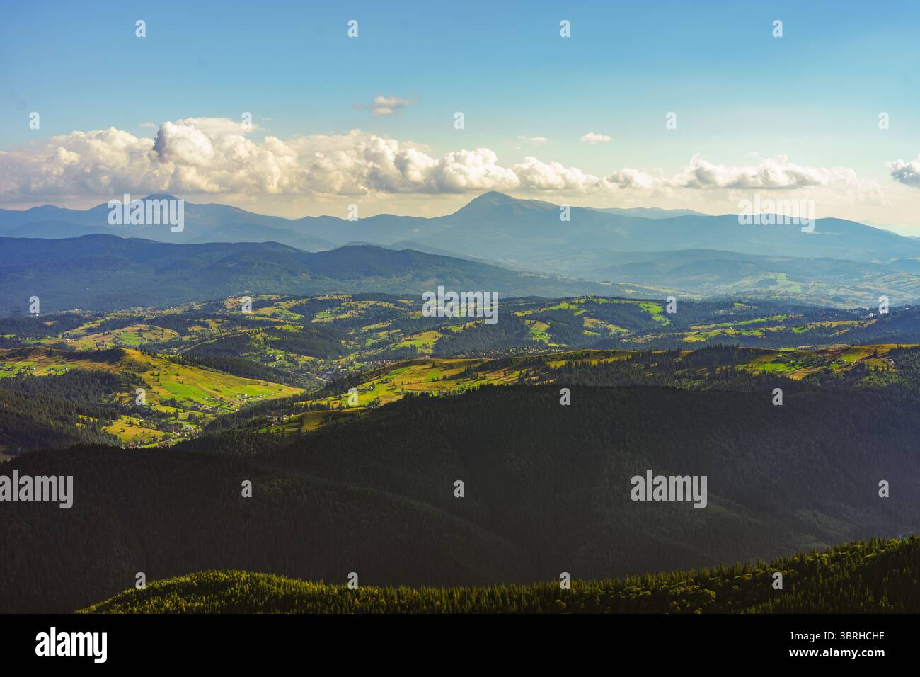 Parallel Mountain Ridges Atmospheric view of multiple mountain ridges covered with green ...