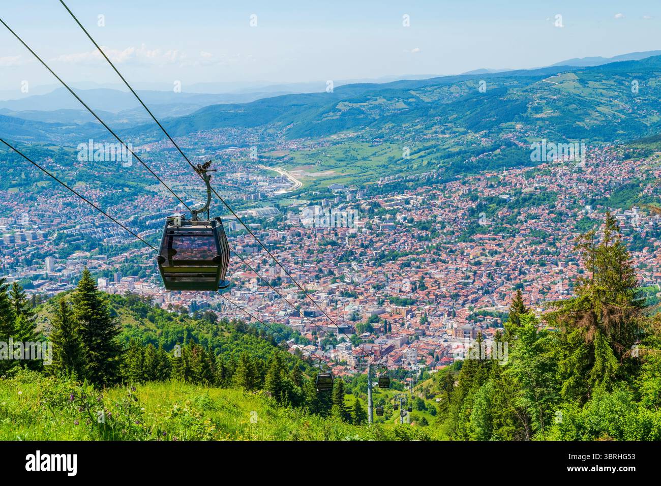 Aerial view of Sarajevo and Cable Car arriving at the top of the Mount ...