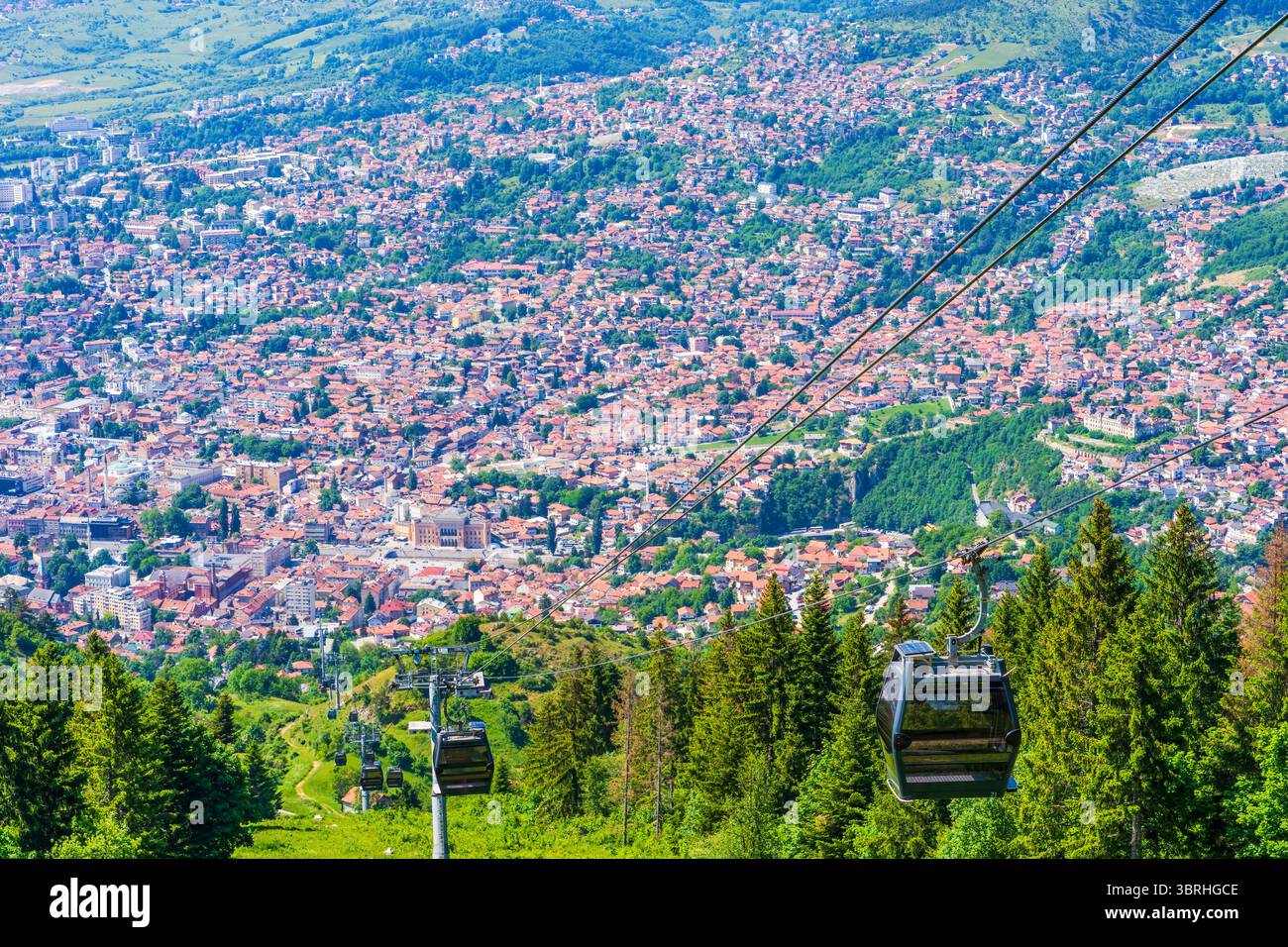 Aerial view of Sarajevo and Cable Car arriving at the top of the Mount ...