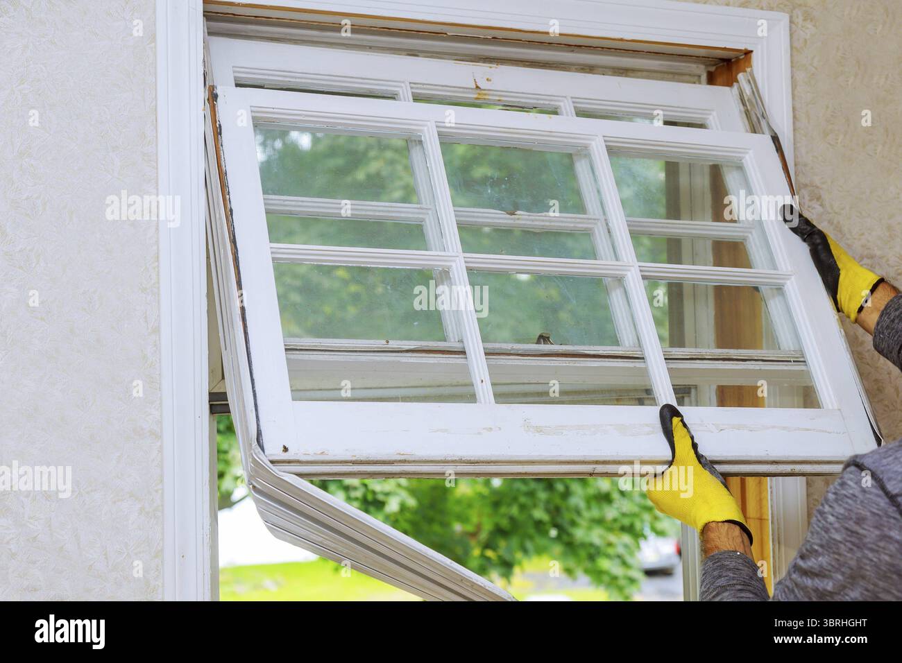 Worker hand removing old window replacing the old wooden window Stock ...