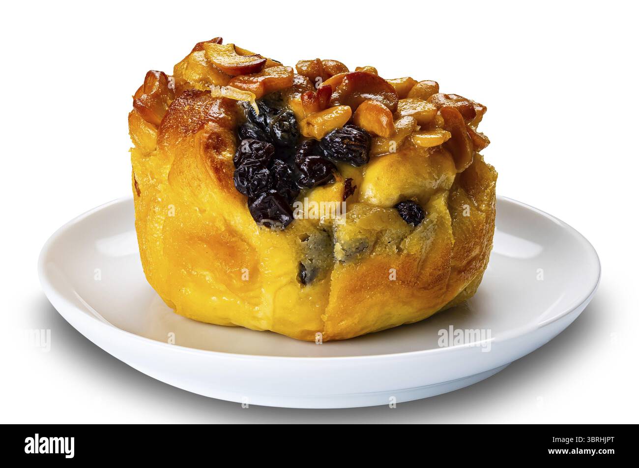 Butter bun garnished with raisin and nuts in white ceramic dish isolated on white background with clipping path Stock Photo