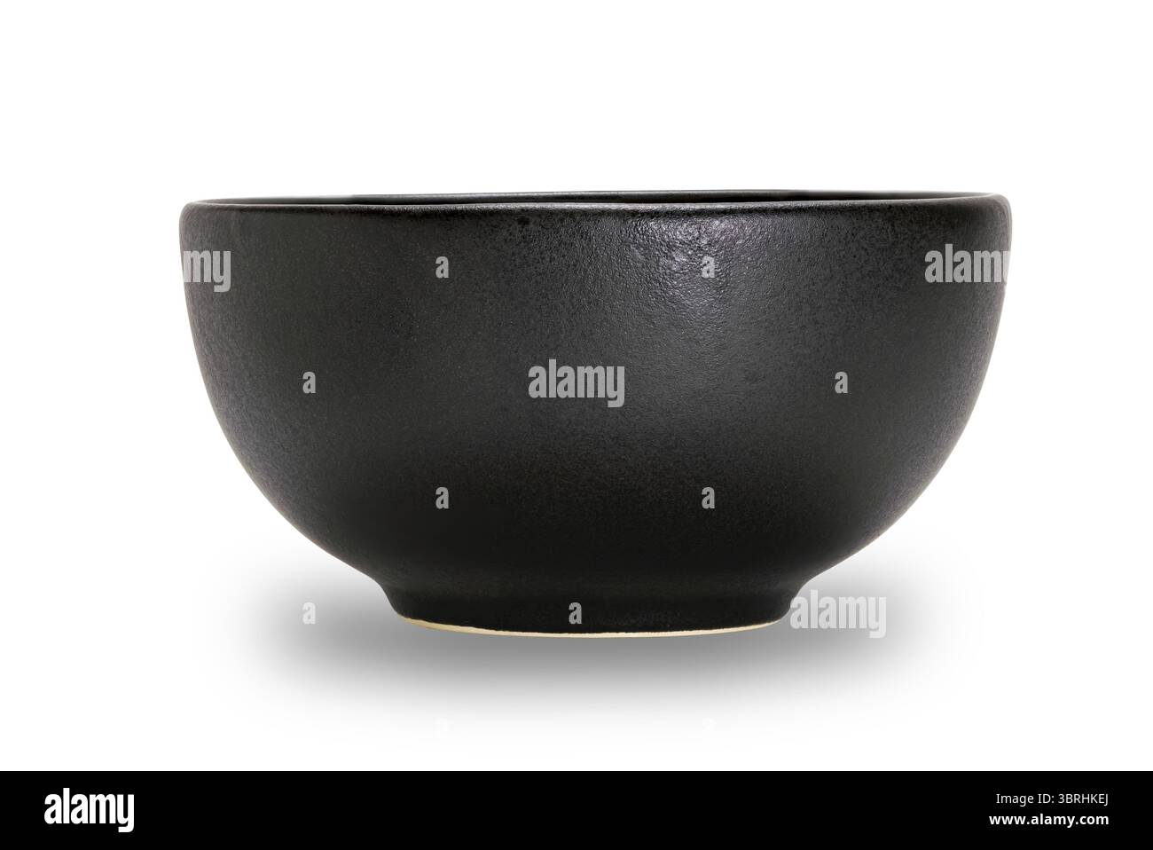 Empty single black ceramic bowl isolated on white background with clipping path, side view, closeup, horizontal format Stock Photo