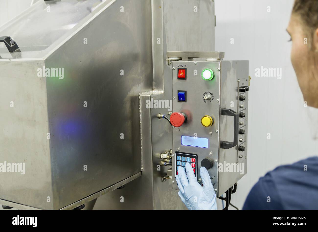 Woman working in industry, adjusting equipament Stock Photo