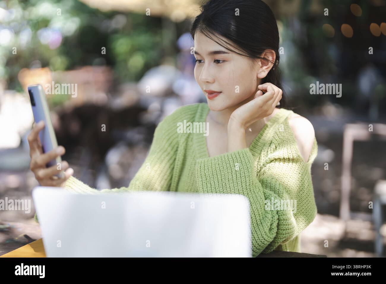 Beautiful confident asian young woman use smart phone college mobile addict spending time checking news technology e-commerce concept Stock Photo