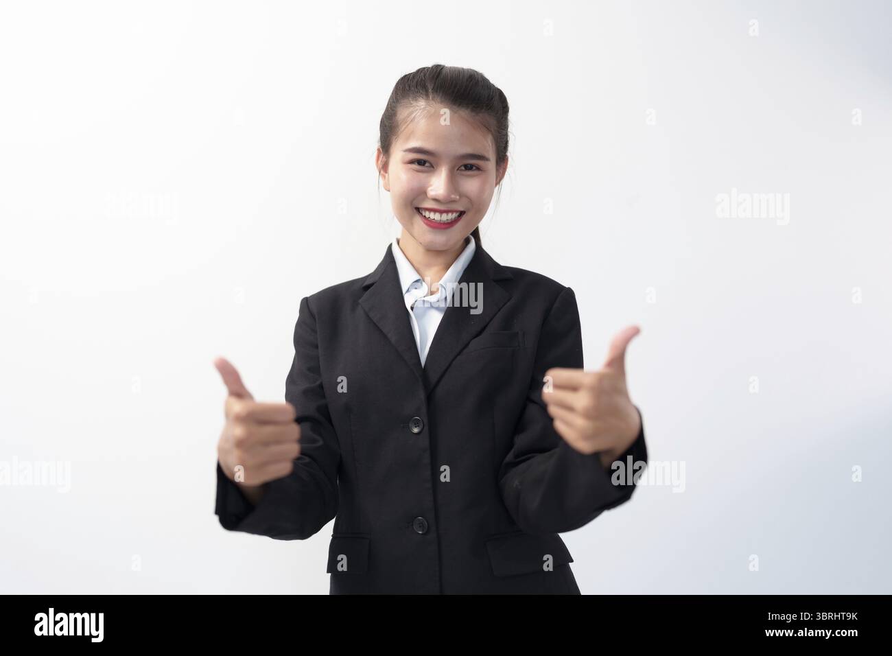 Positive Asian young Business woman showing thumbs up looking at camera ...