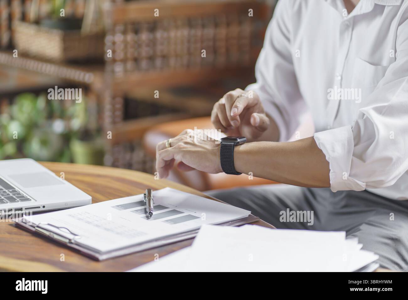 Business man Looking at smart watch In Office online connect Gadget technology Stock Photo