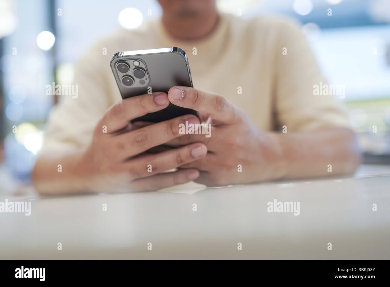 Relaxed young asian man using smart phone spending time checking news social media Stock Photo