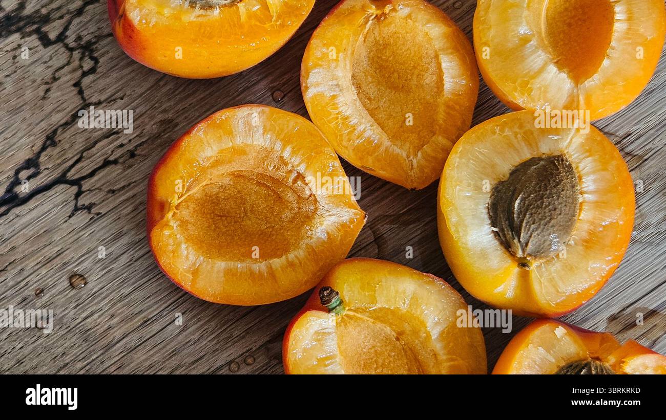 Halved Apricots on Rustic Wooden Table - Smartphone Captured Stock Image