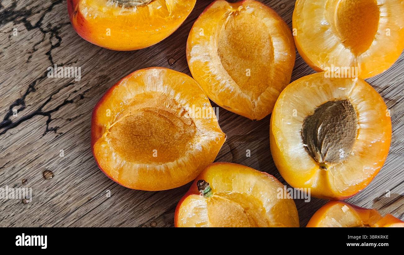 Halved Apricots on Rustic Wooden Table - Smartphone Captured Stock Image
