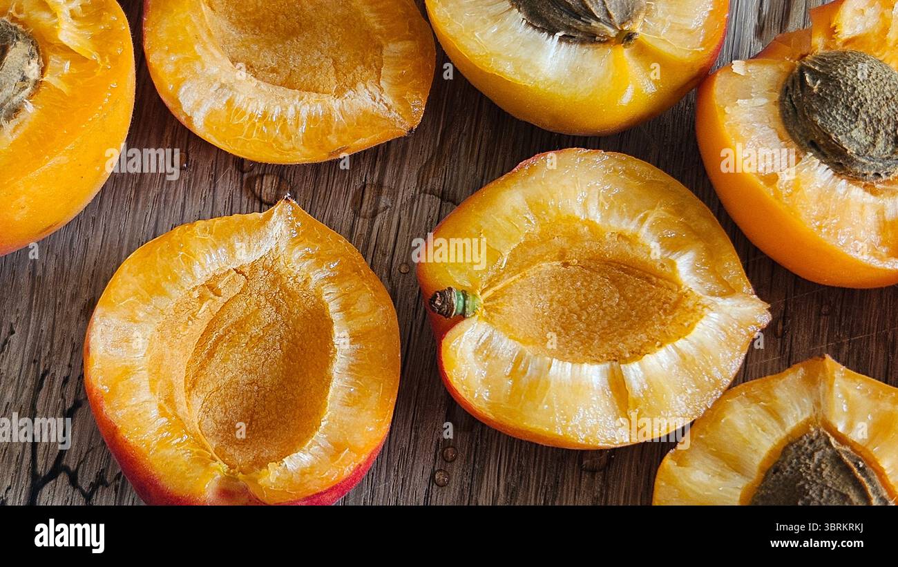 Halved Apricots on Rustic Wooden Table - Smartphone Captured Stock Image