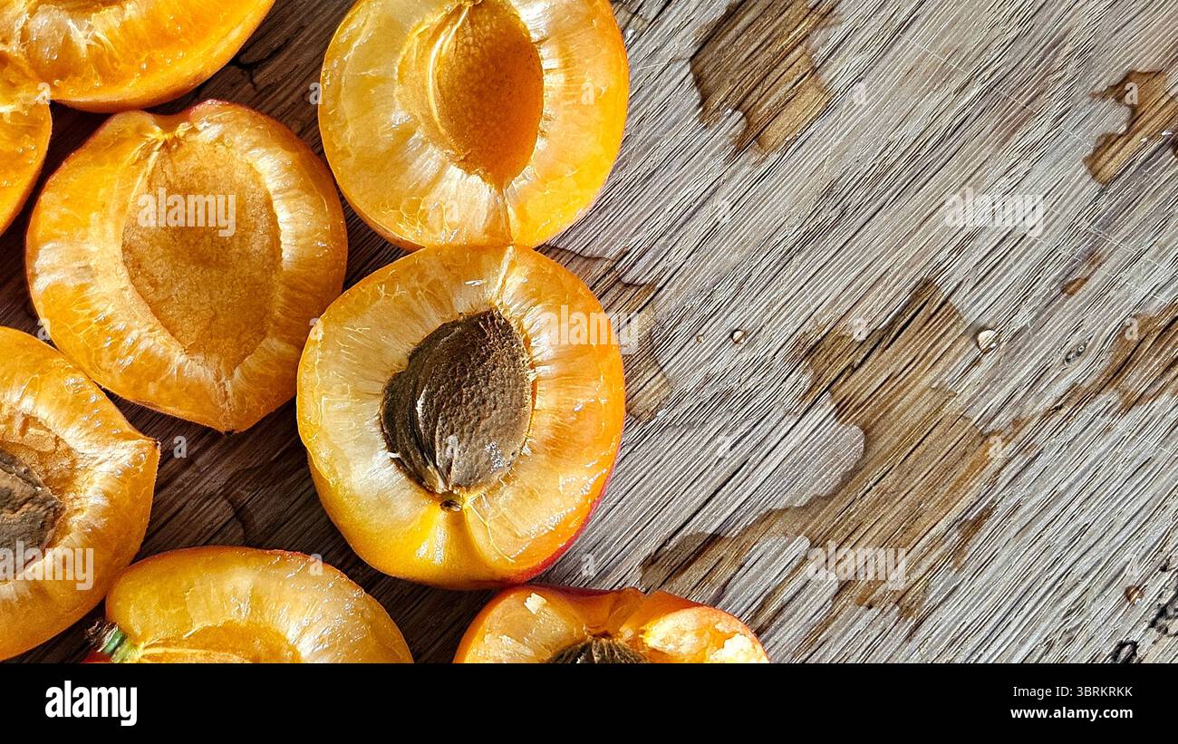 Halved Apricots on Rustic Wooden Table - Smartphone Captured Stock Image