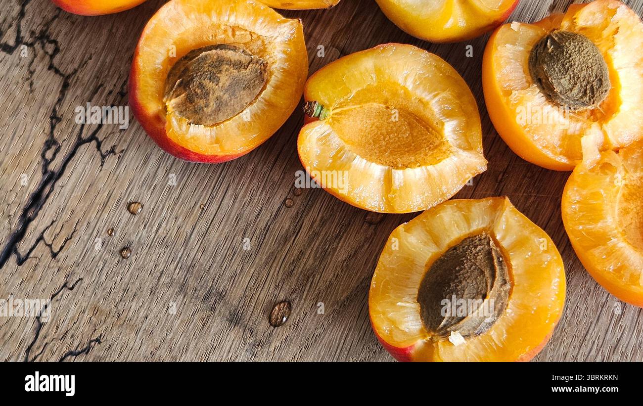 Halved Apricots on Rustic Wooden Table - Smartphone Captured Stock Image