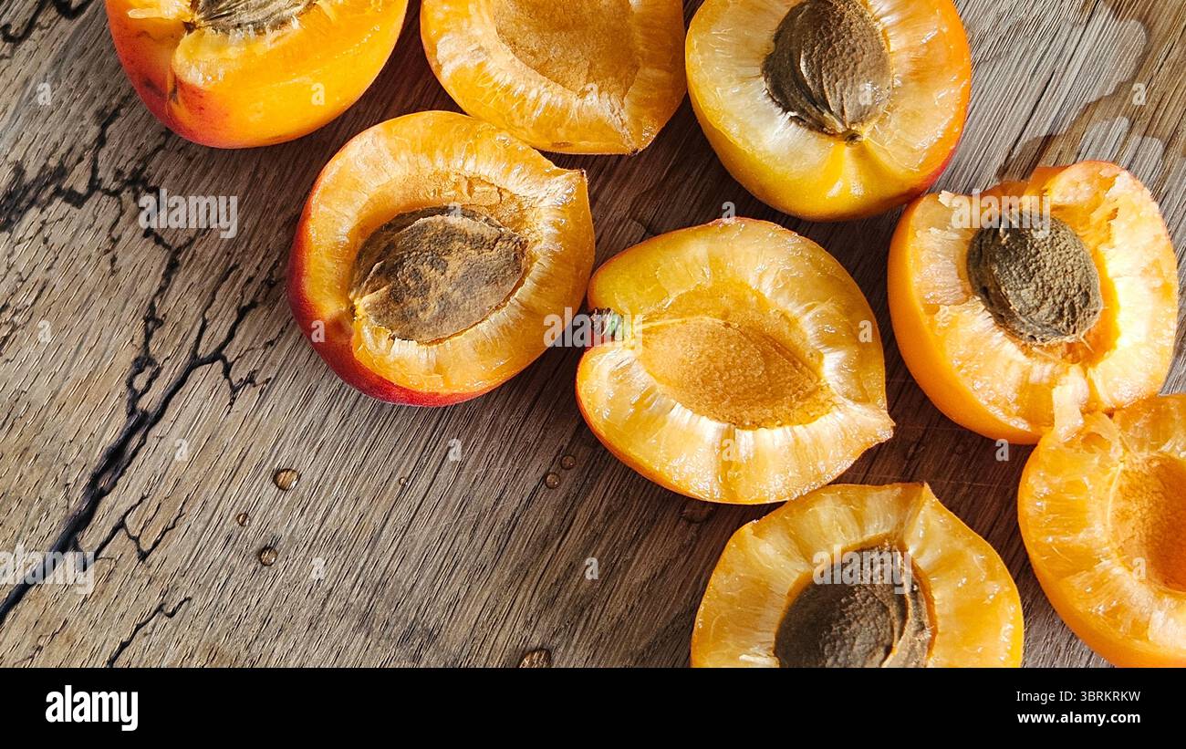 Halved Apricots on Rustic Wooden Table - Smartphone Captured Stock Image
