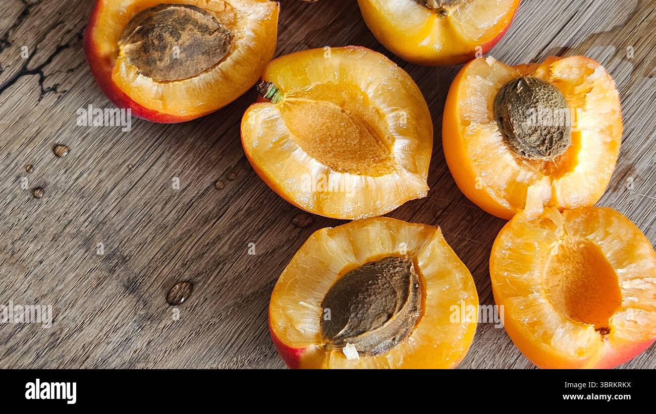 Halved Apricots on Rustic Wooden Table - Smartphone Captured Stock Image