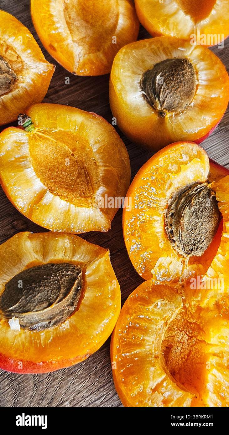 Halved Apricots on Rustic Wooden Table - Smartphone Captured Stock Image