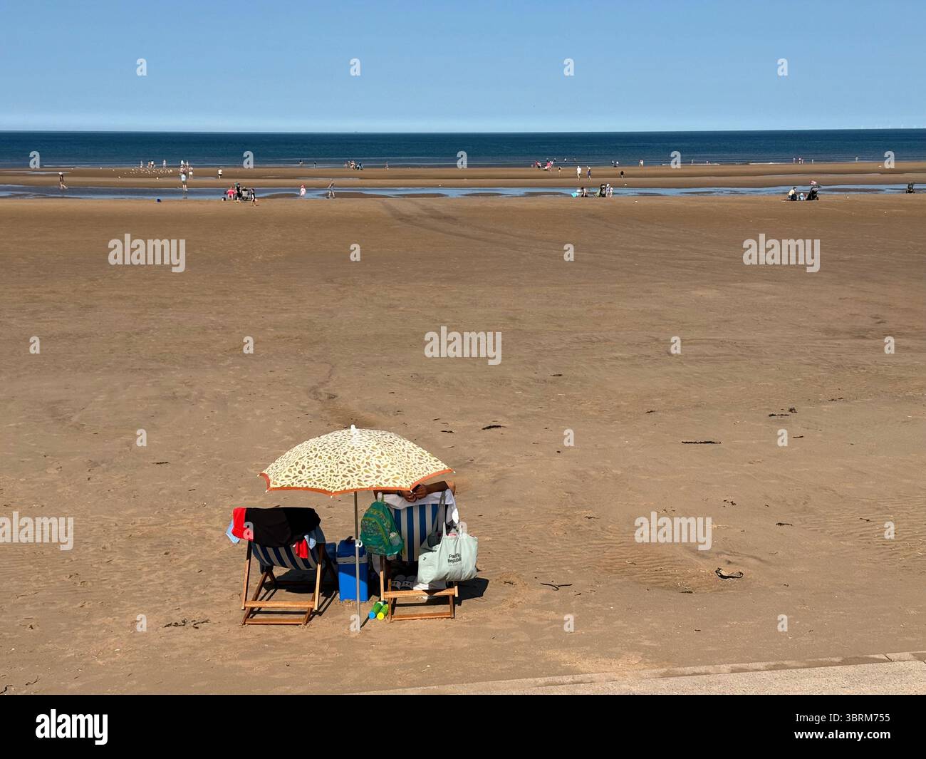 Deckchairs and sun shade on Blackpool Beach on a sunny day - Smartphone Captured Stock Image