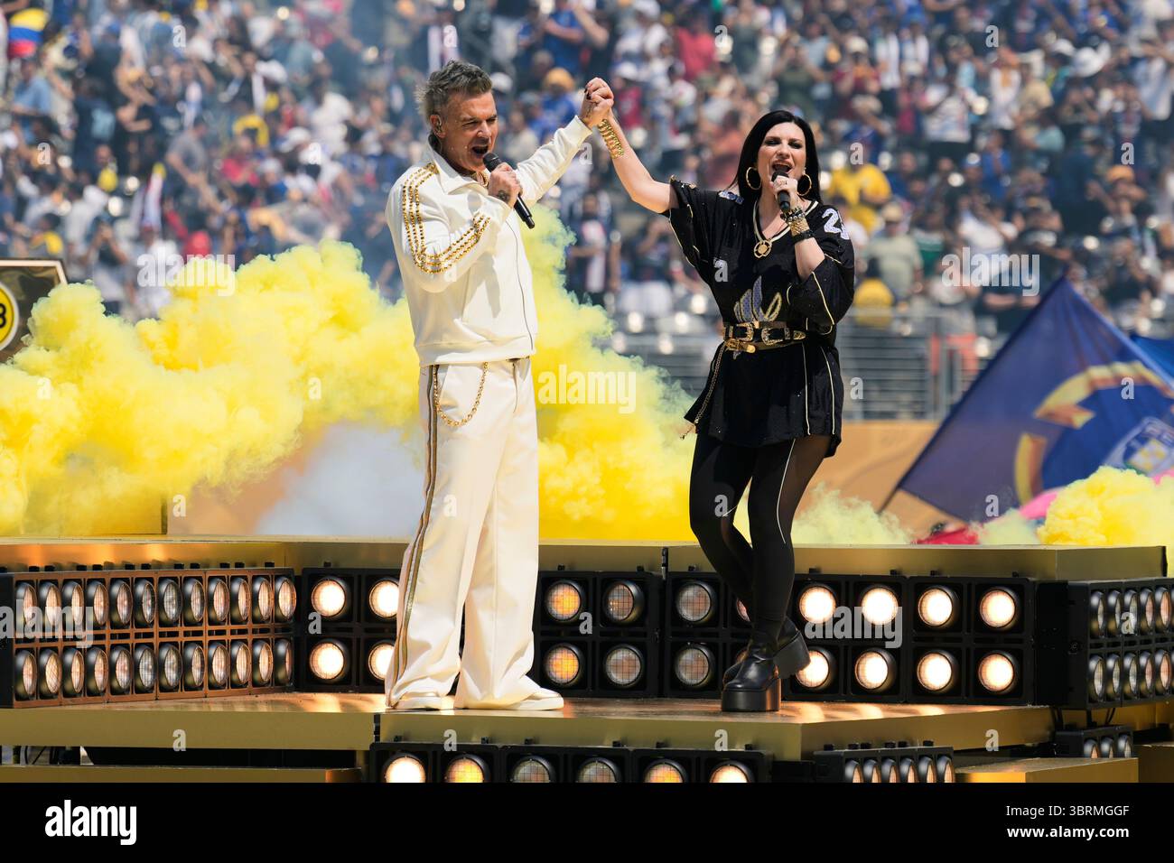 Robbie Williams and Laura Pausini perform during a pregame show before ...