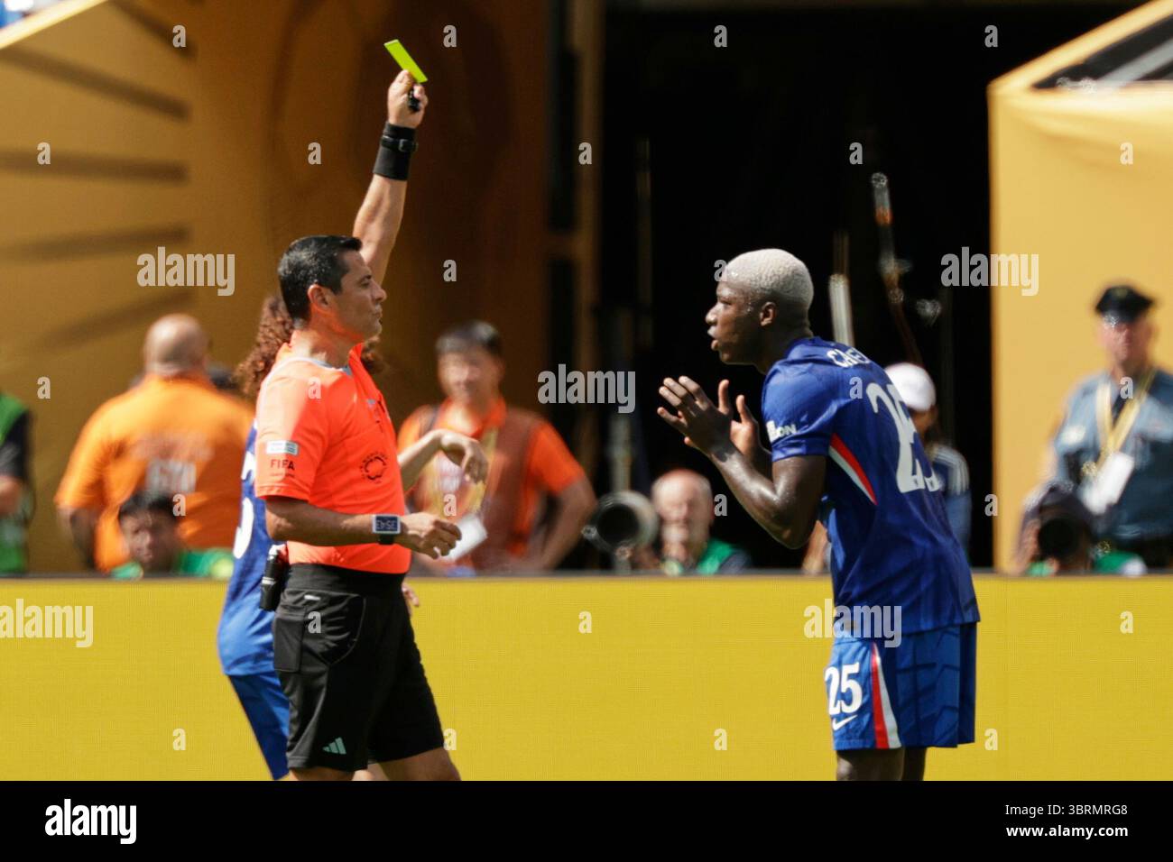 Referee Alireza Faghani shows the yellow card to Chelsea's Moises ...