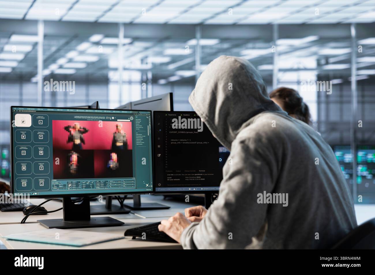 System administrator in server hub coding AI program turning text prompt into photos. Hooded man in data center using computer to build text to image artificial intelligence generative models Stock Photo