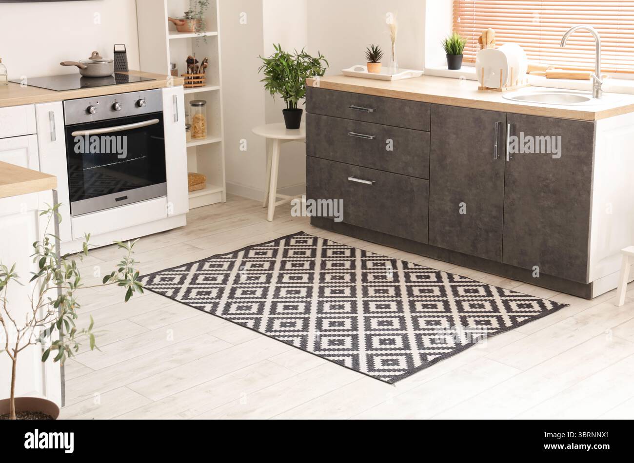 Interior of light kitchen with counters and carpet Stock Photo - Alamy