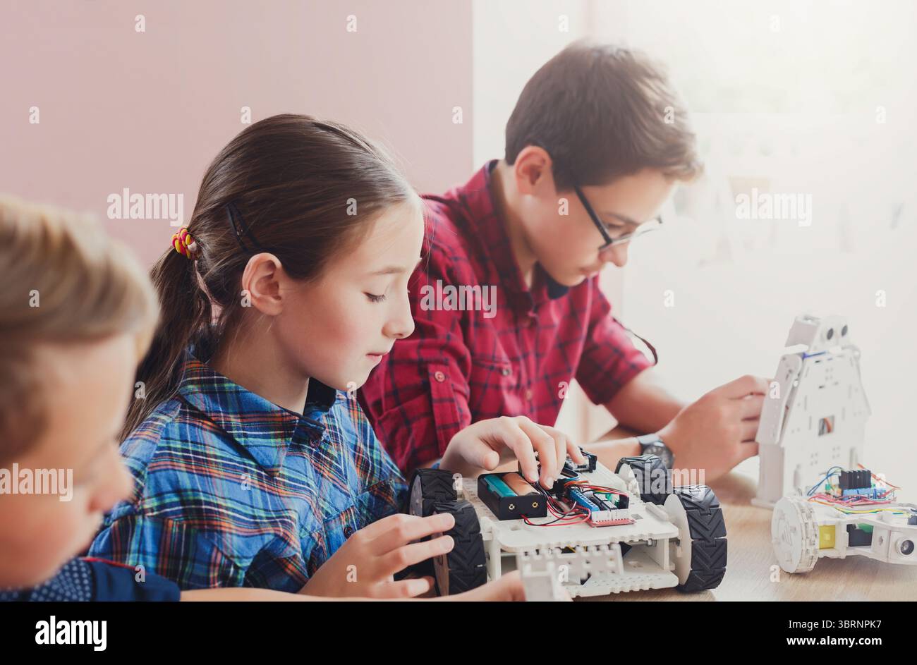 Stem education. Kids creating robots at school Stock Photo - Alamy
