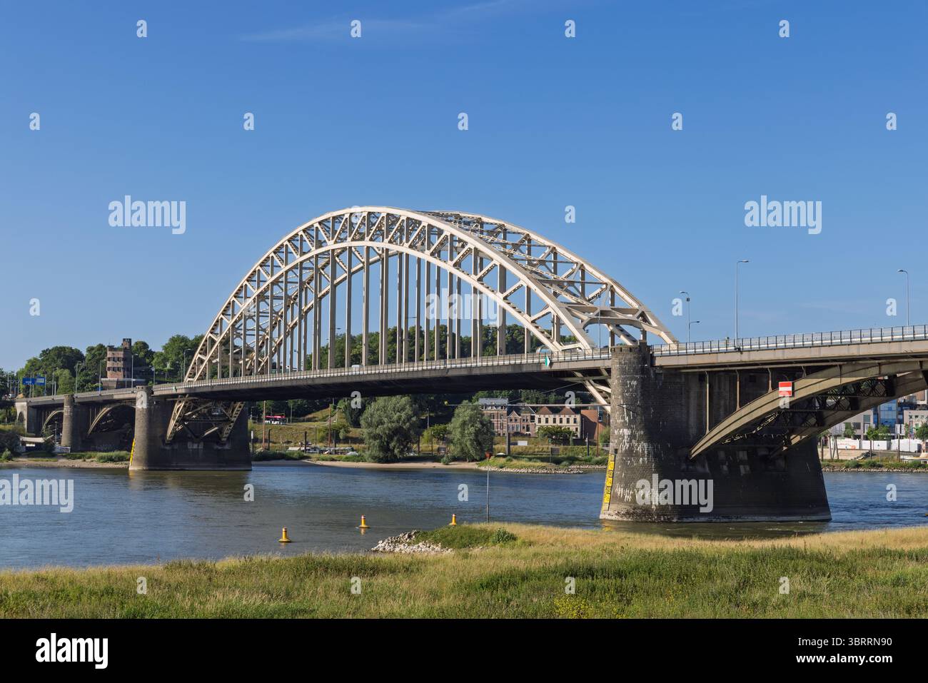 The Grand Waalbrug A Prominent Arch Bridge Spans The Waal River In the-grand-waalbrug-a-prominent-arch-bridge-spans-the-waal-river-in