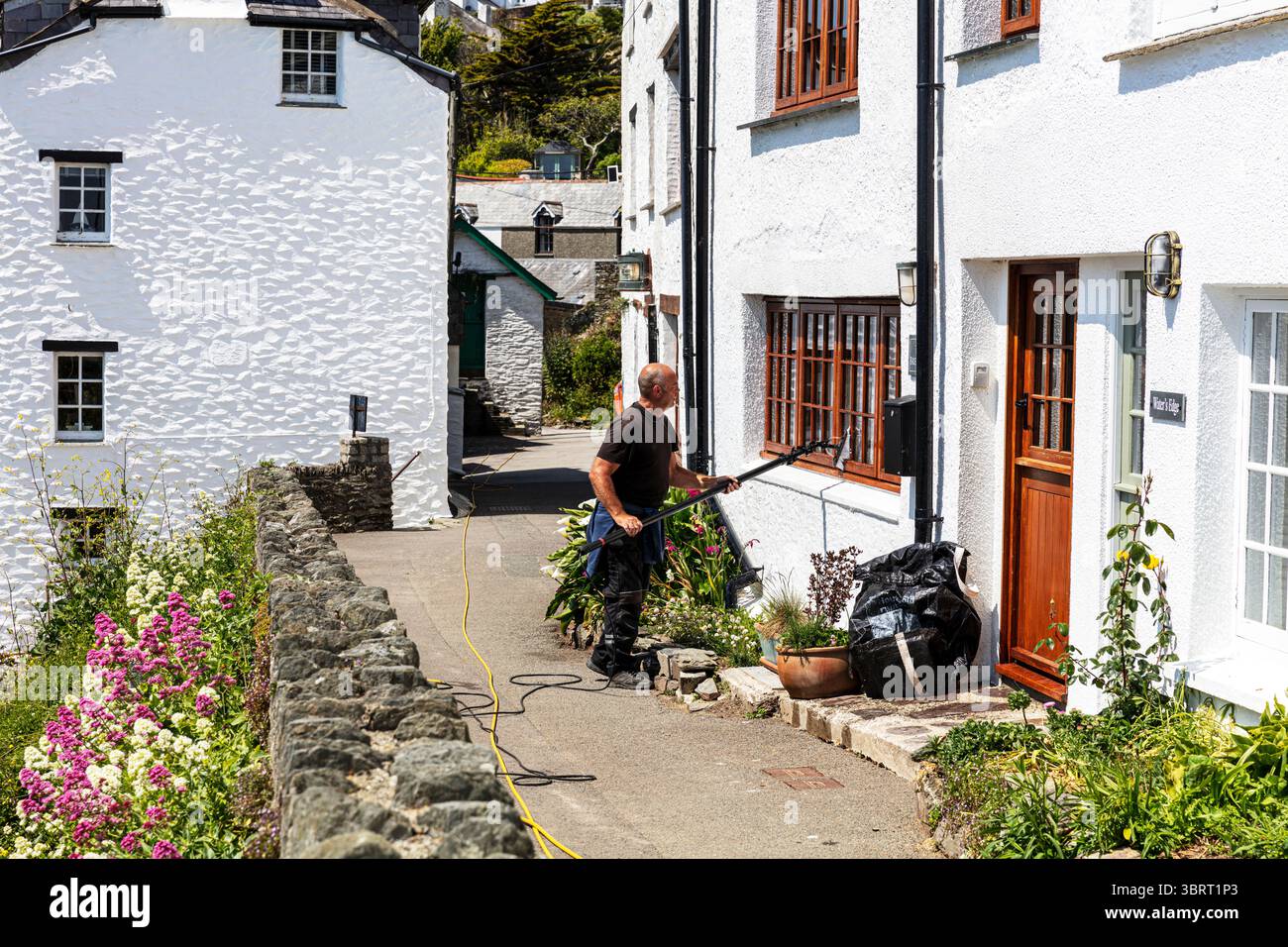 window cleaner, cleaning windows, pole window cleaner, cleaning, washing, windows, washing windows, water fed pole, using water fed pole, Stock Photo