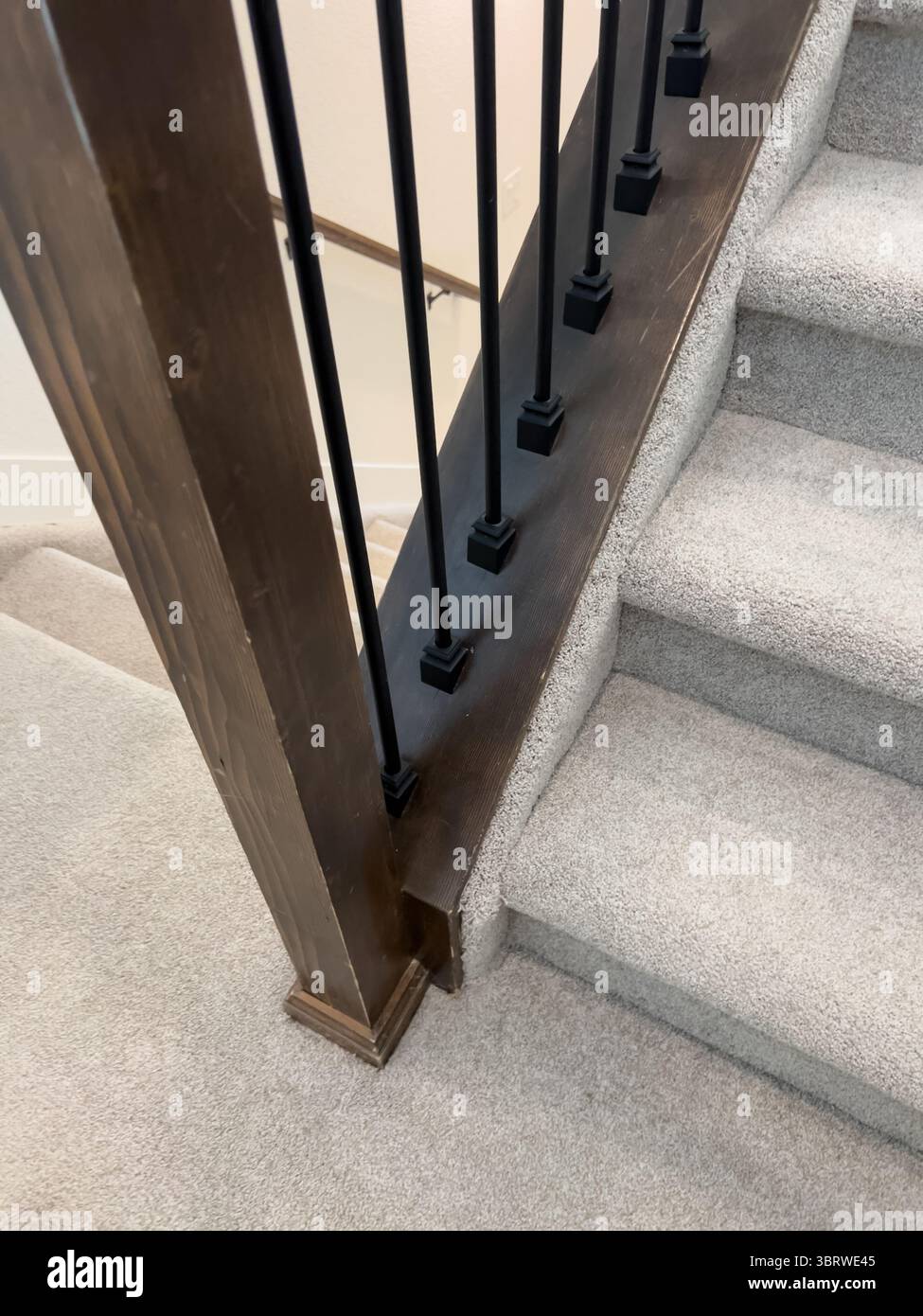 Stair Base with Wood Rail and Beige Carpet Stock Photo - Alamy