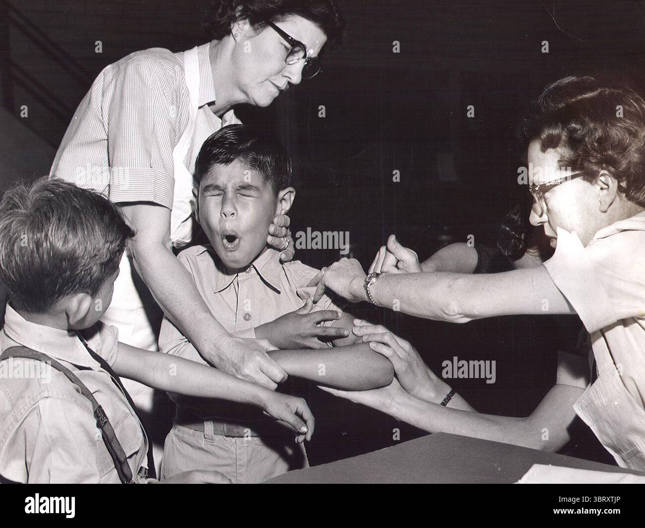 Nov 5, 1958 - San Antonio, Texas, U.S. - Undated File Photo c. late 1950's - A schoolboy gets Polio vaccine. The first polio vaccine was the inactivated polio vaccine. It was developed by Jonas Salk and came into use in 1955. The oral polio vaccine was developed by Albert Sabin and came into commercial use in 1961. (Credit Image: © San Antonio Express-News/ZUMAPRESS.com) Stock Photo