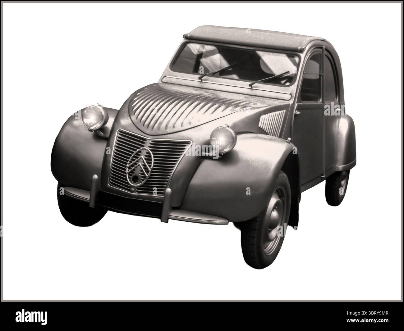 Citroen 2CV, an iconic economy car produced by the French company Citroën from 1948 to 1990.  The 2CV, or deux chevaux (meaning 'two horses' in French), was originally conceived as the 'Toute Petite Voiture' (Very Small Car) project in 1936, aiming to provide affordable and versatile transportation for low-income households.  It was known for its innovative design, including an easy-to-service air-cooled engine, radial tires, and a famously soft suspension, which reputedly allowed it to carry a basket of eggs across a ploughed field without breaking any. Stock Photo
