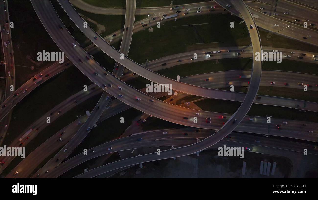 Aerial view of a sprawling highway interchange with ribbons of light ...