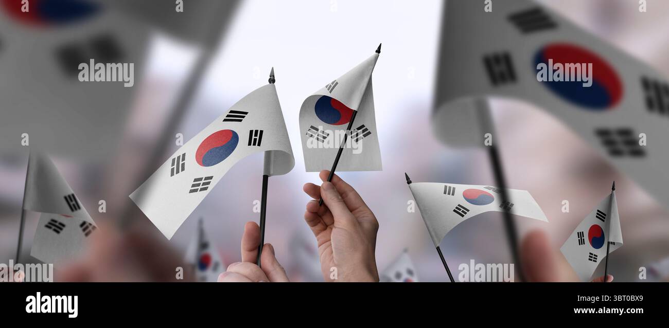 South Korean flags in their hands on a blurred urban background Stock ...