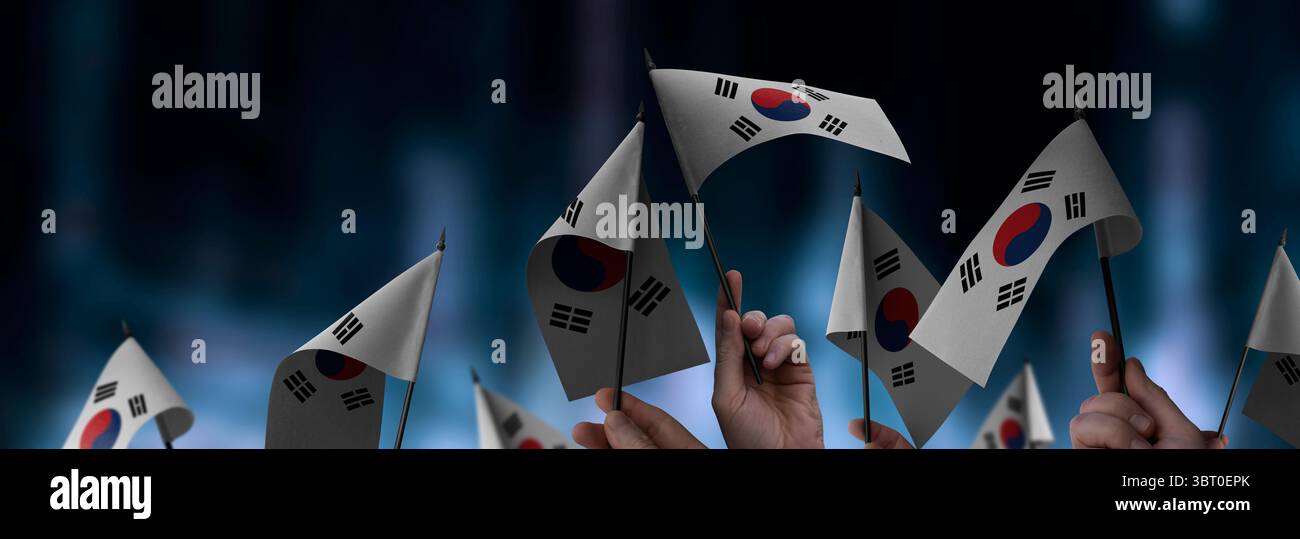 South Korean flags in their hands on a blurred urban background Stock ...
