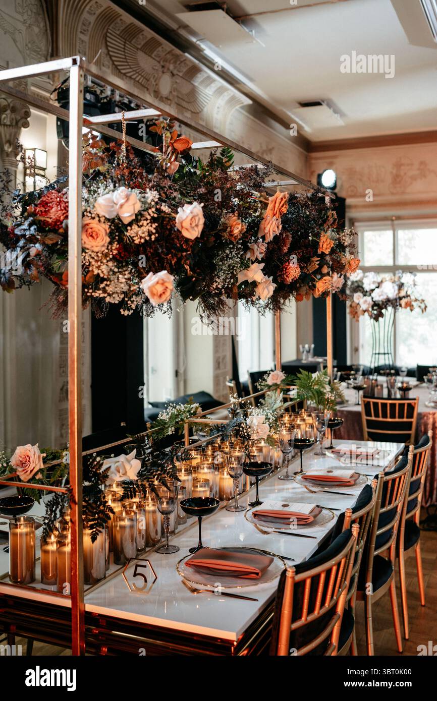 Luxurious indoor dining setup with elegant floral arrangements and ...