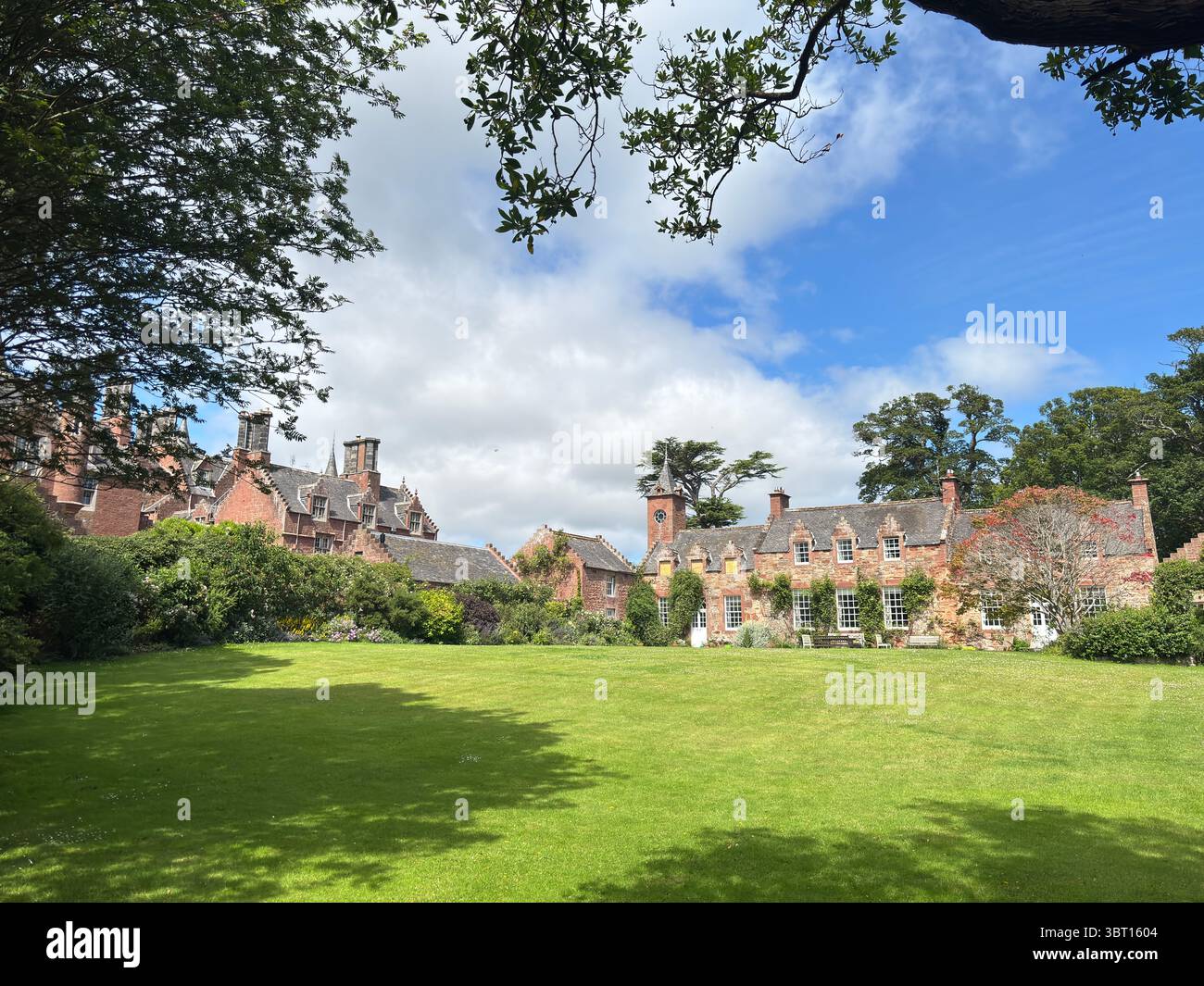 Tyninghame House, a red-sandstone Scots baronial mansion near the River Tyne estuary, set in expansive gardens—built in 1829 over earlier medieval Stock Photo