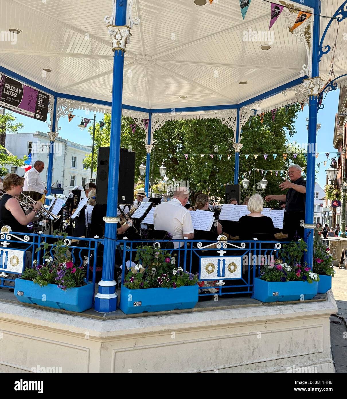 A town centre bandstand in Horsham, West Sussex, with band playing in Summer - Smartphone Captured Stock Image