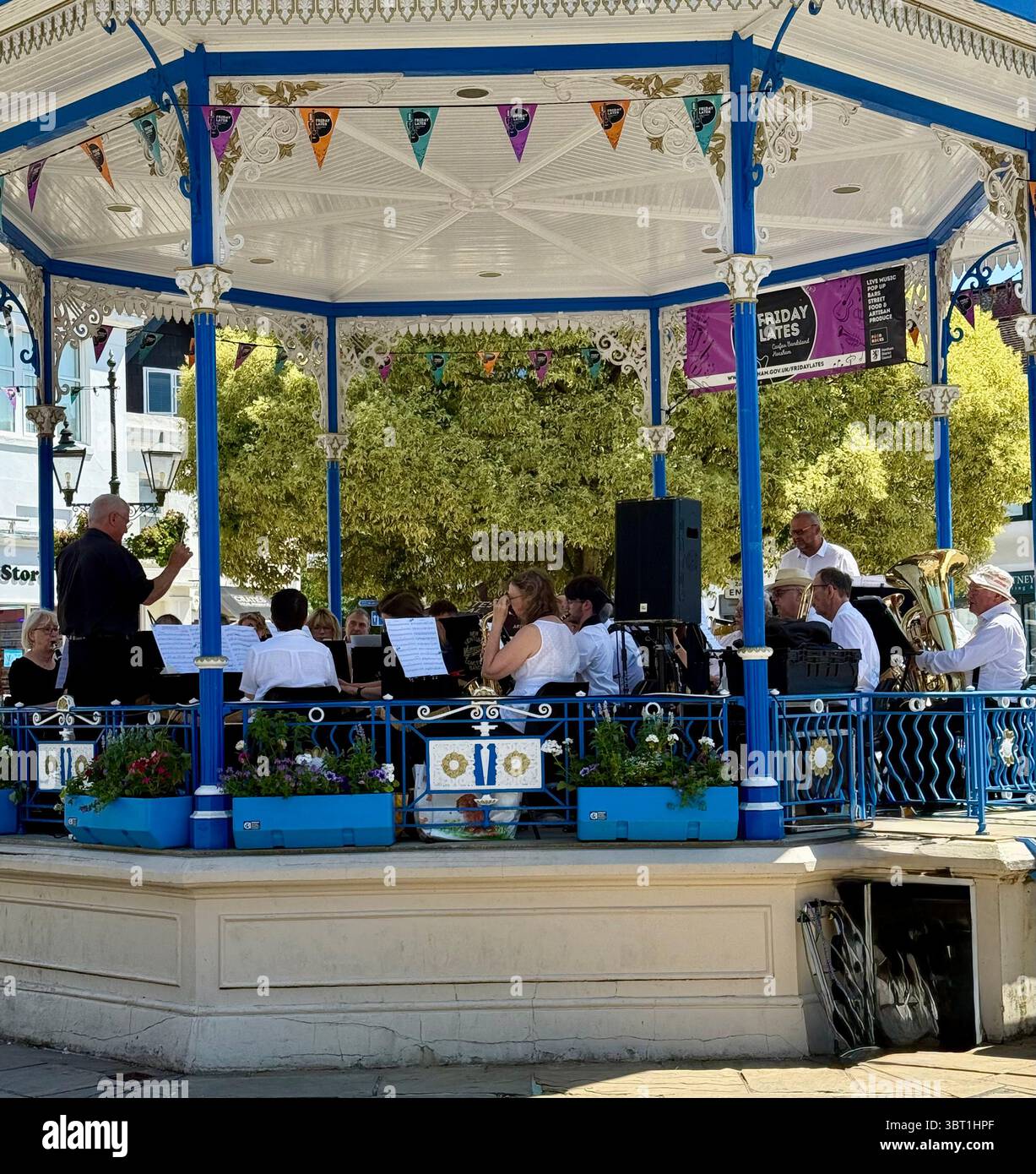 A town centre bandstand in Horsham, West Sussex, with band playing in Summer - Smartphone Captured Stock Image