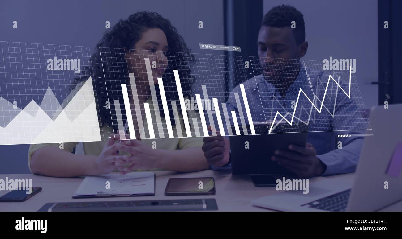 Analysts analyzing data overlay in business attire at office conference ...