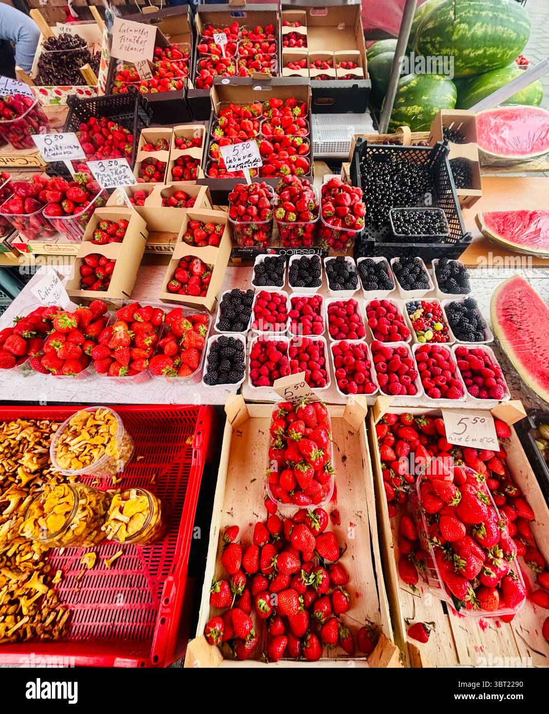Strawberries and blueberries displayed by a vendor at the Halės Turgus market in Vilnius, Lithuania. - Smartphone Captured Stock Image