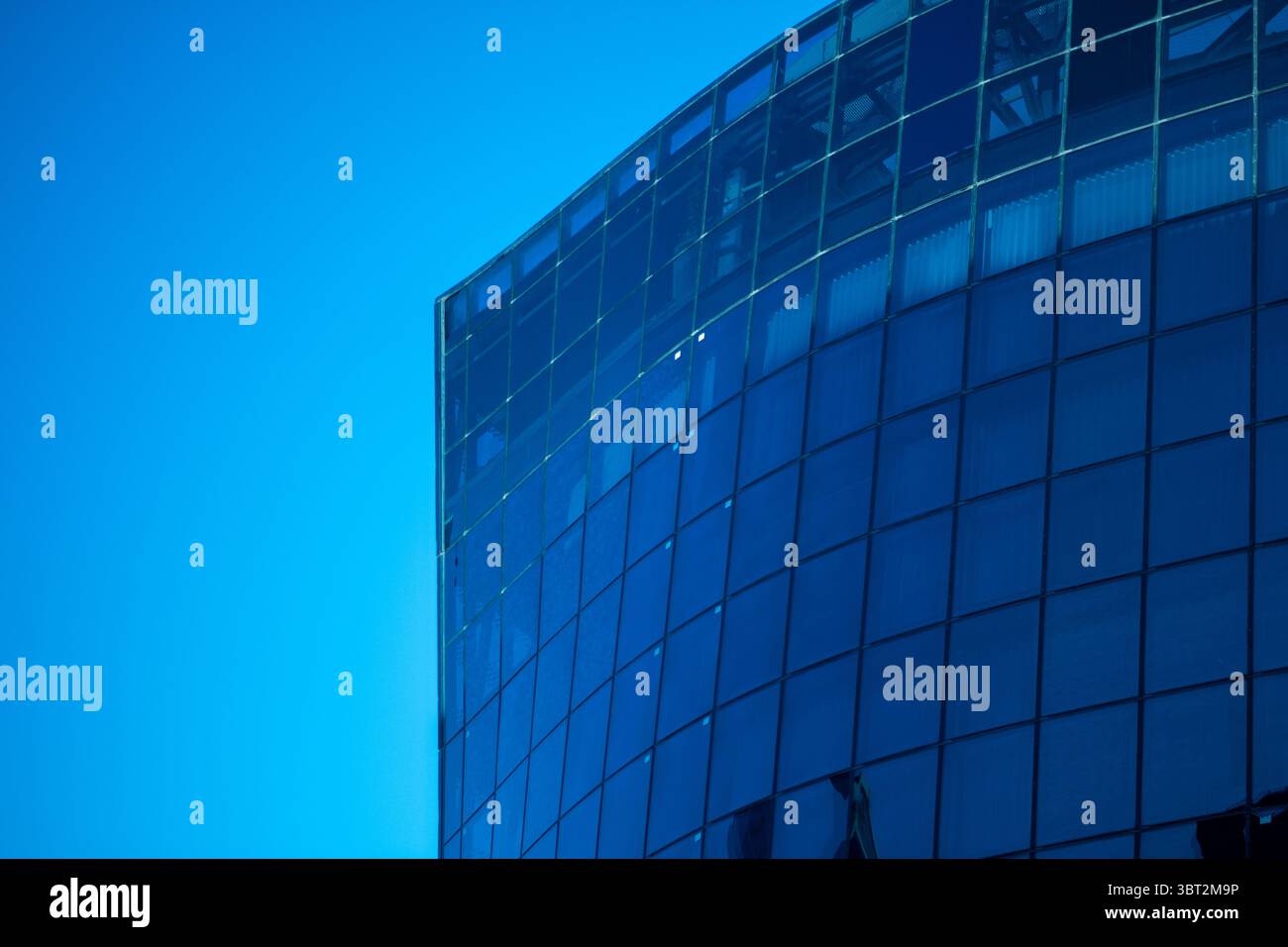 Abstract architecture background featuring modern glass building facade Stock Photo