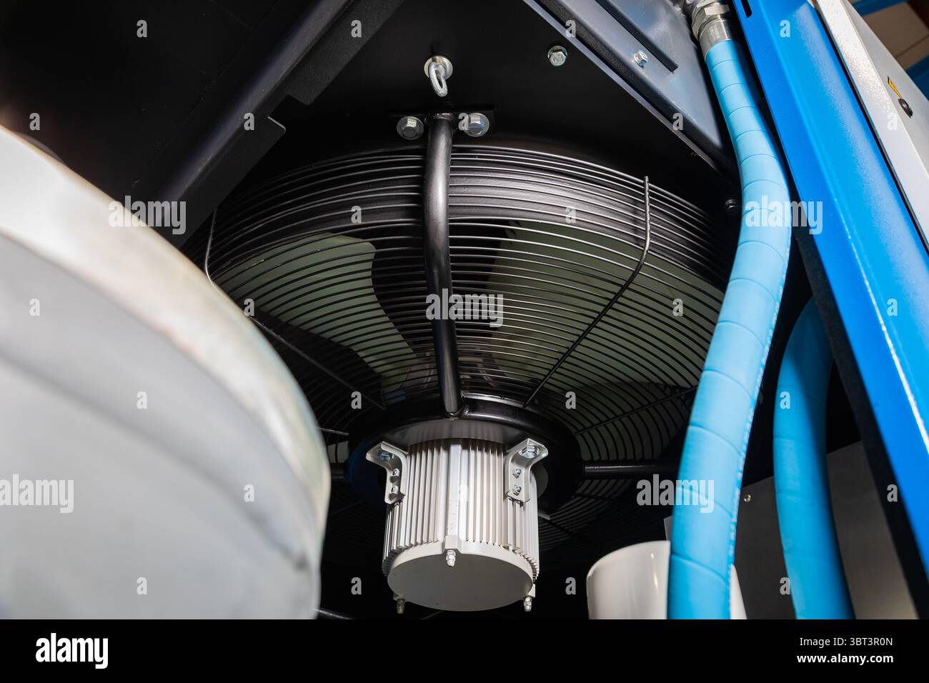 Close up of a cooling fan operating inside an industrial air compressor ...