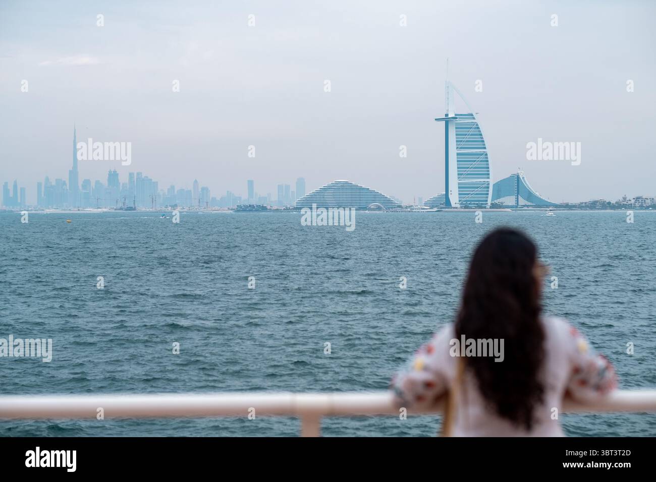 Woman looking dubai skyline across hi-res stock photography and images ...