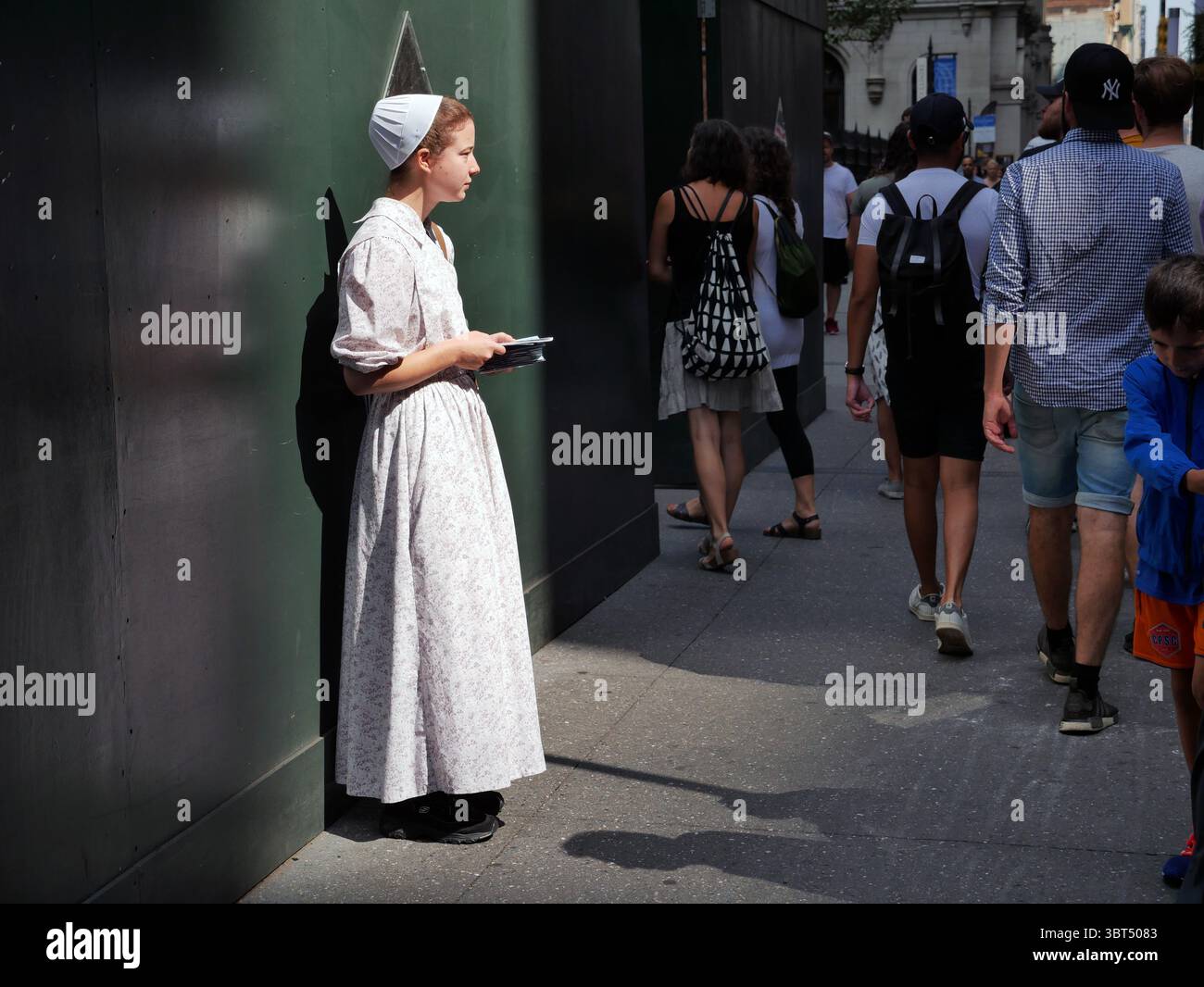 September 11, 2019 - New York, New York, USA - Mennonite woman giving out prayer cards on Broadway NYC on 9/11. Praying for peace. (Credit Image: © Milo Hess/ZUMA Wire) Stock Photo