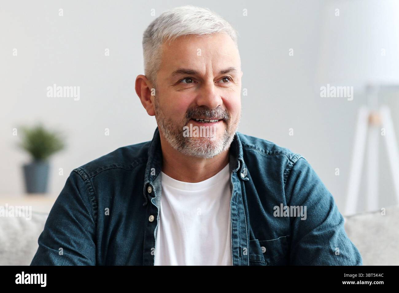 Happy old man with mug looking at copy space Stock Photo