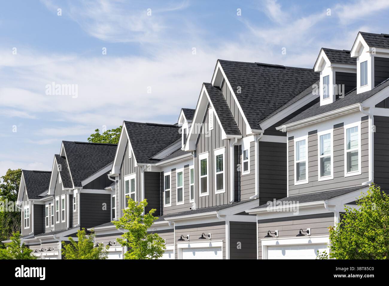 detail-of-a-row-of-grey-and-white-modern-farmhouse-townhomes-with-board