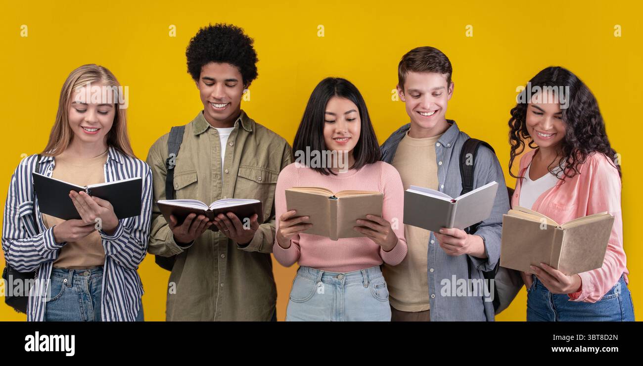 Happy young university students studying with books in library Stock Photo