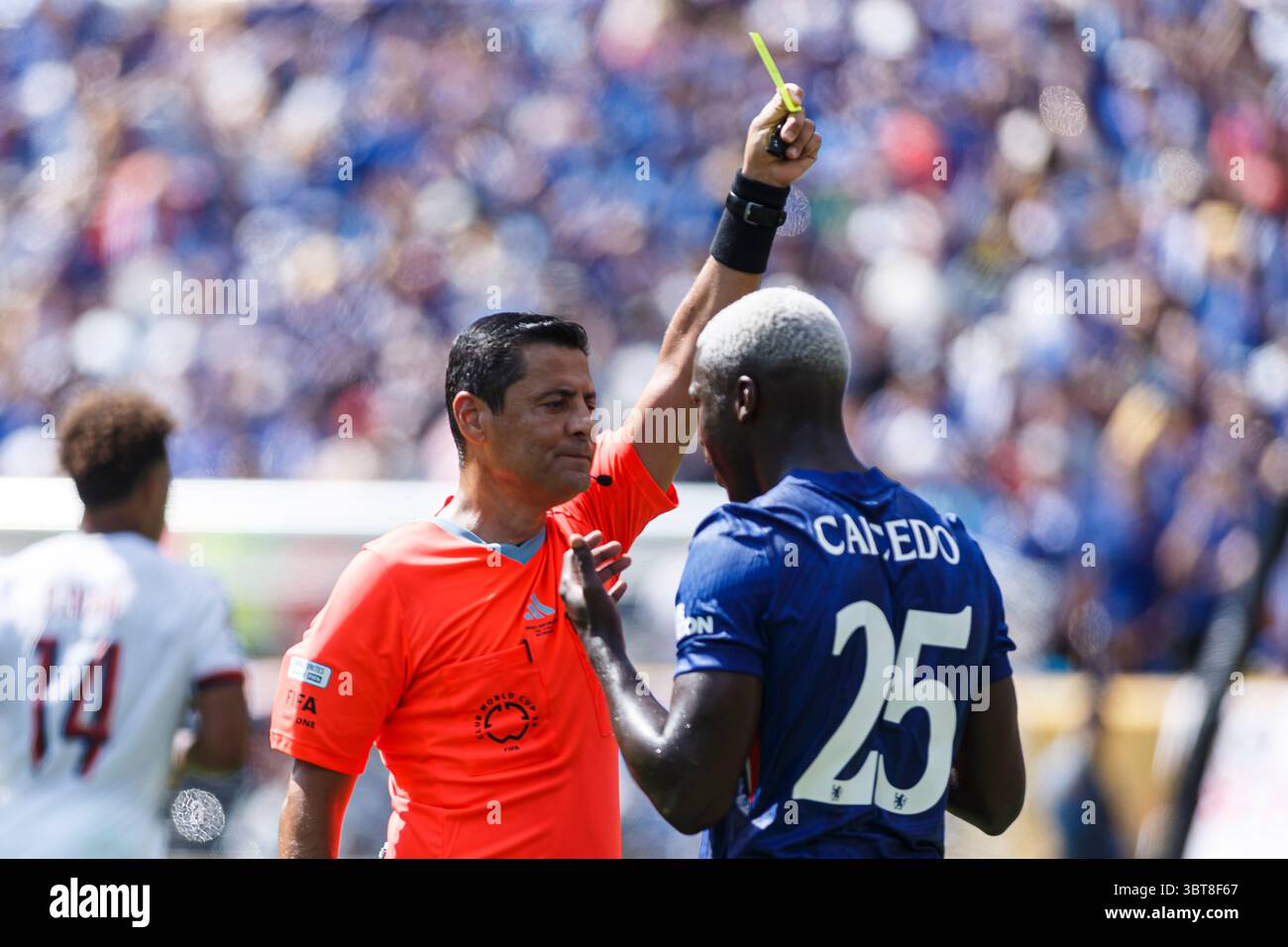 New Jersey - July 13: Referee Alireza Faghani (L) shows a yellow card ...
