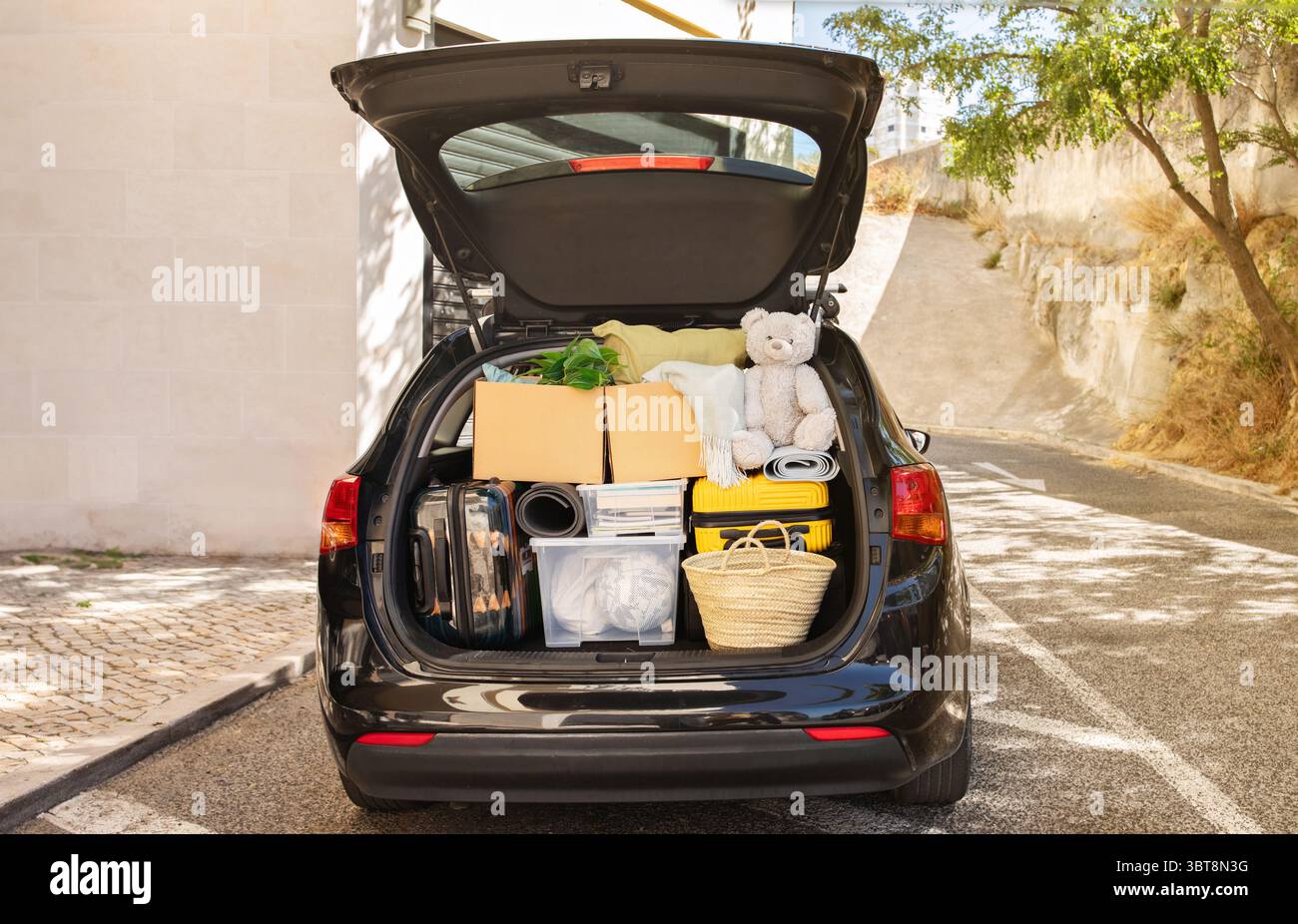 Moving boxes and suitcases in trunk of car, outdoors Stock Photo - Alamy
