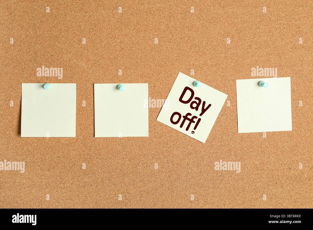 Paper notes with text DAY OFF on cork board Stock Photo